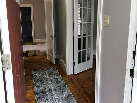 Hall with office/bedroom with French doors to right with door to rest of apartment.