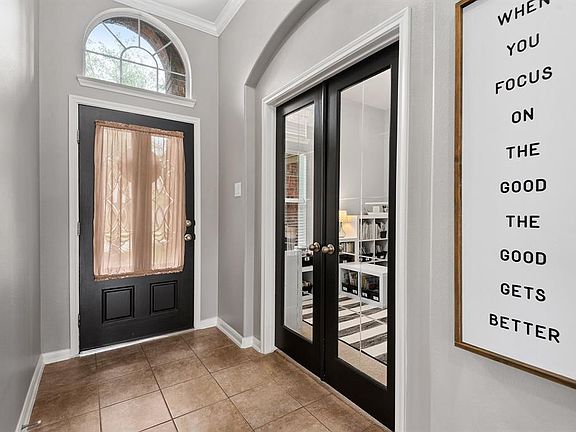 As you enter the front door, an office/study is to your left with gorgeous glass double doors.