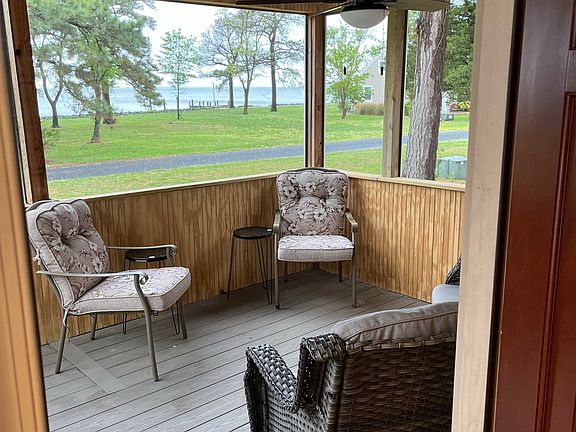 Enjoy the beauty of tranquil island living with spectacular water view from the screened in front porch.