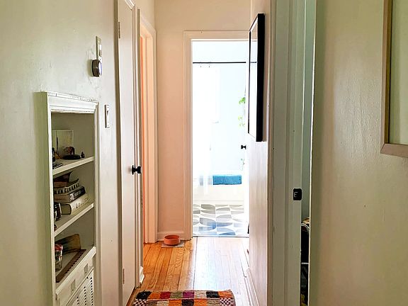 Hallway connecting living space to bedrooms and bathroom