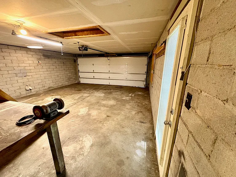 Two car garage with closet and attic storage. Also includes dryer (installed) and hookup for washer in separate room.