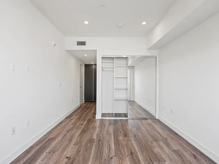 Bedroom with Closet with Built-In Shelving