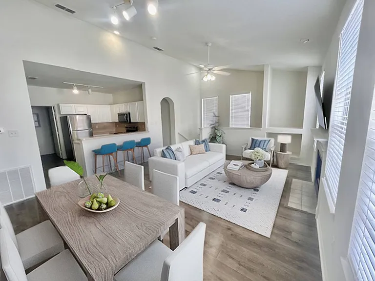 Living room and kitchen with bright natural light at Windsor Highwoods Preserve apartments