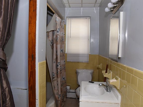 Full Bathroom. Shower and Bathtub sink and toilet. Window for natural light.