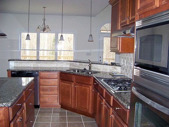 Kitchen w/ granite surfaces