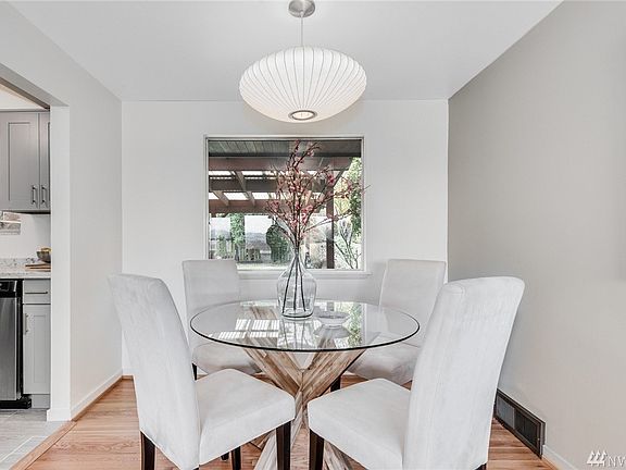 Formal dining space with iconic Nelson bubble lamp overlooks covered patio and private backyard.