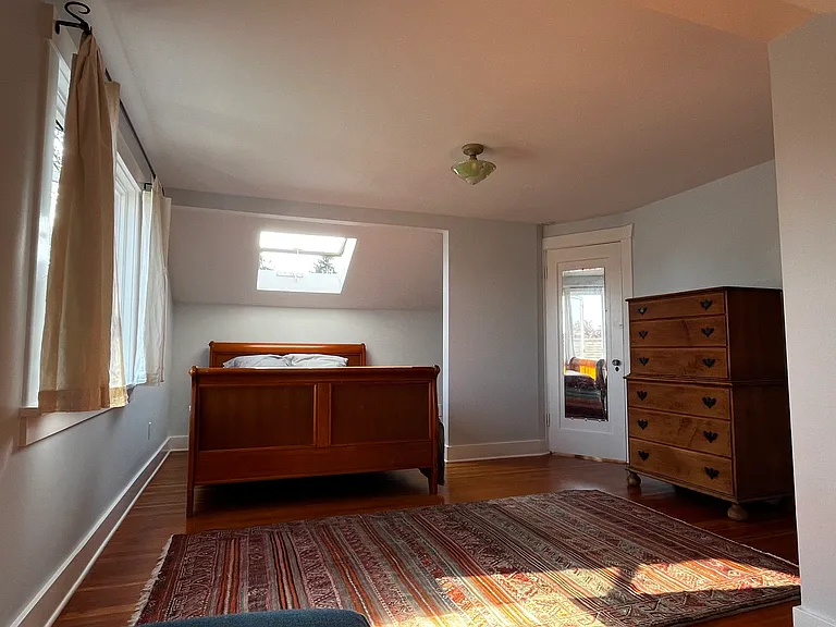 Queen bed under a skylight.