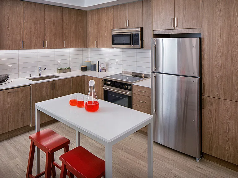Our kitchens feature stainless steel appliances, tile backsplash and wood-grain cabinets