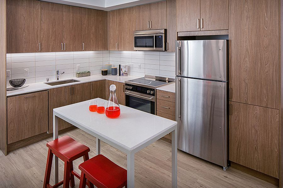 Our kitchens feature stainless steel appliances, tile backsplash and wood-grain cabinets