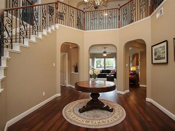 Impressive grand 2-story foyer with sweeping wrought iron staircase and hardwood floors welcomes you in!