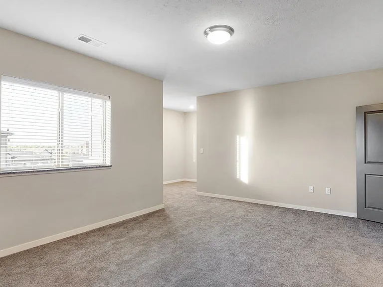 Experience comfort and privacy in this spacious bedroom.
