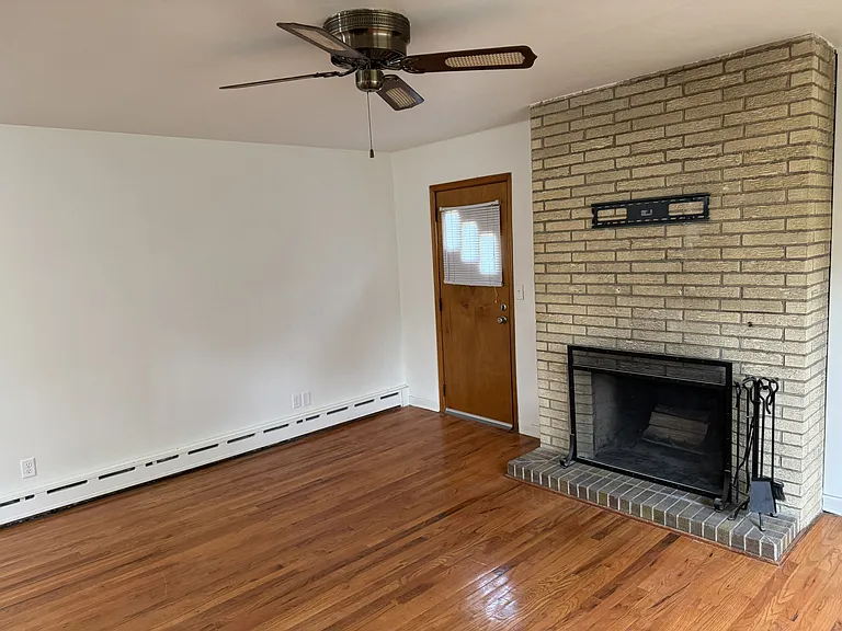 Brick fireplace and door to side yard.