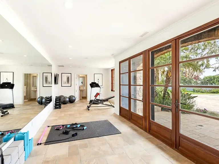 Gym with treadmill, weights, and more