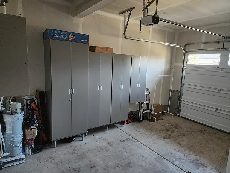 garage with plenty of cabinet along with single car