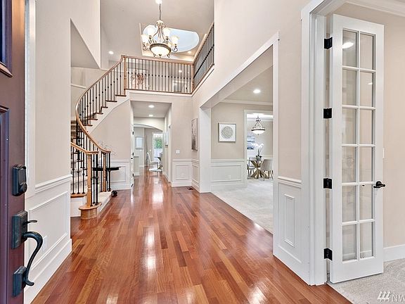 Grand foyer with 2-story high ceiling and Brazilian cherry hardwood floors. Bonus office or guest suite off to your right with glass pane French doors.