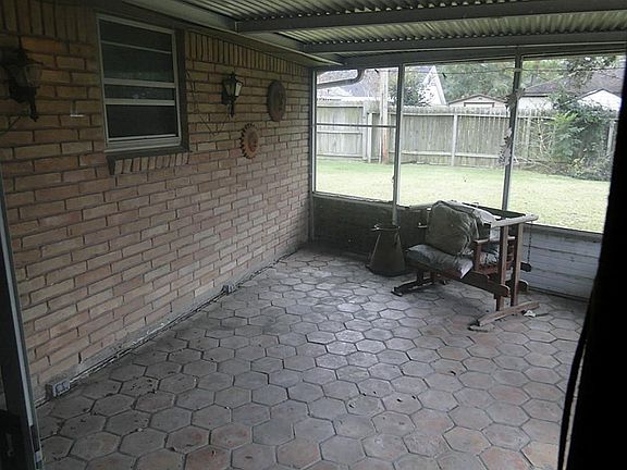 Enclosed back patio with tile floor