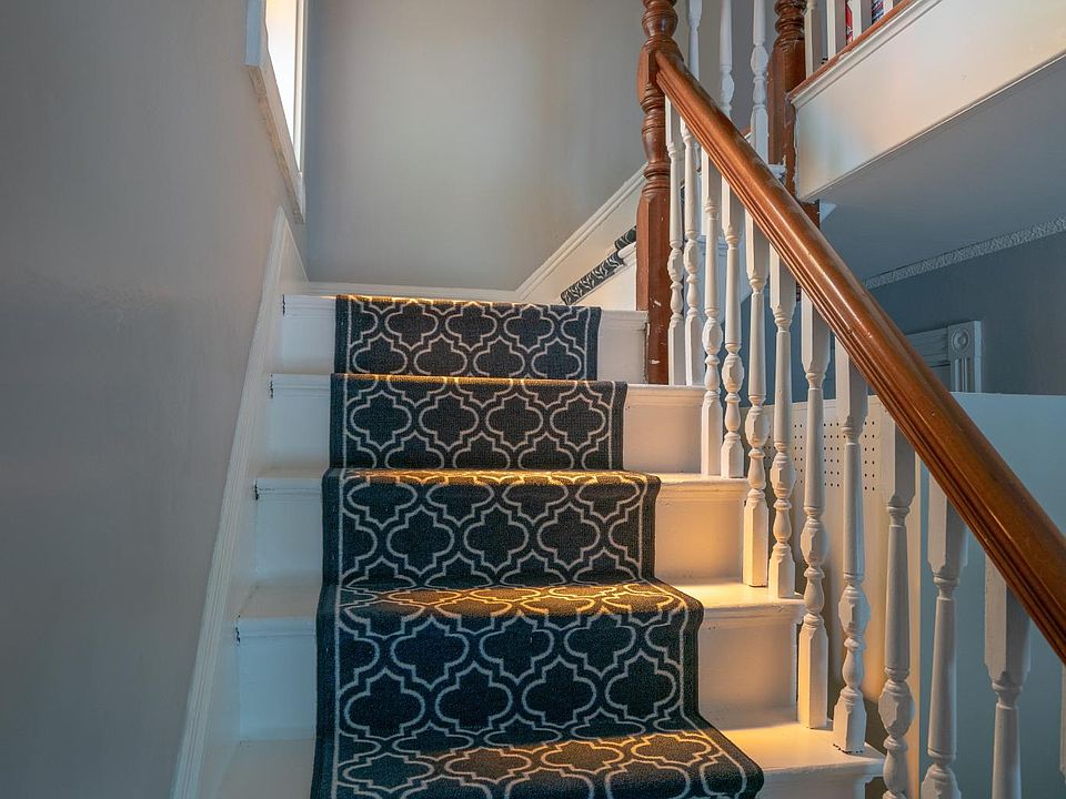 Going through the private entrance brings you to the main staircase. Fresh paint and carpet really makes this space feel inviting.
