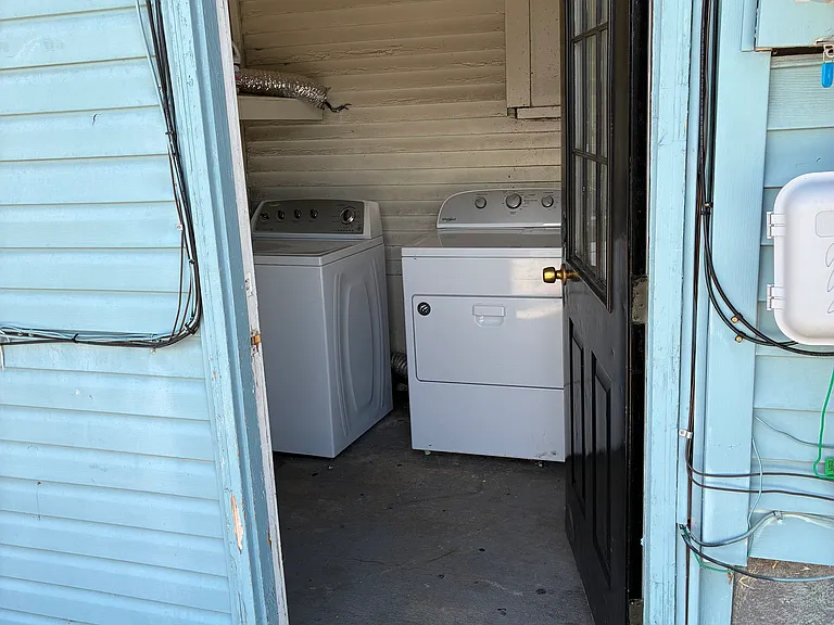 shared laundry room with upstairs tenants