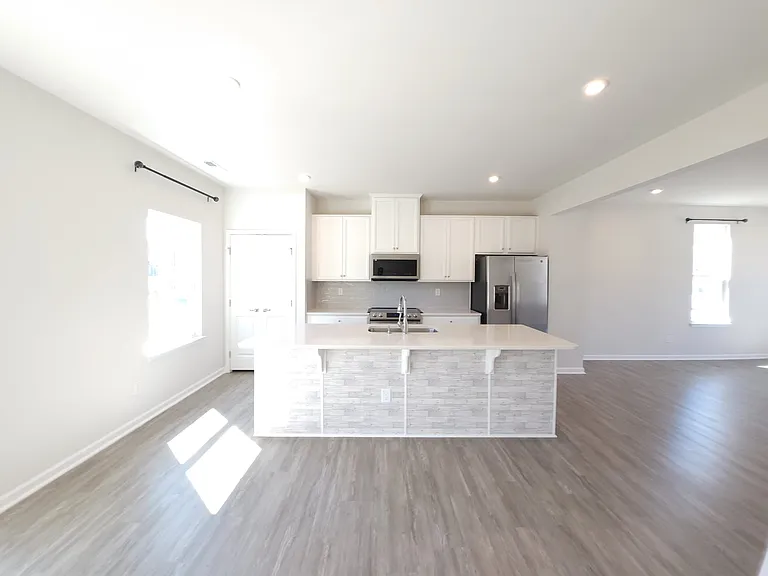 beautiful and sunny kitchen with a large island for four high chairs