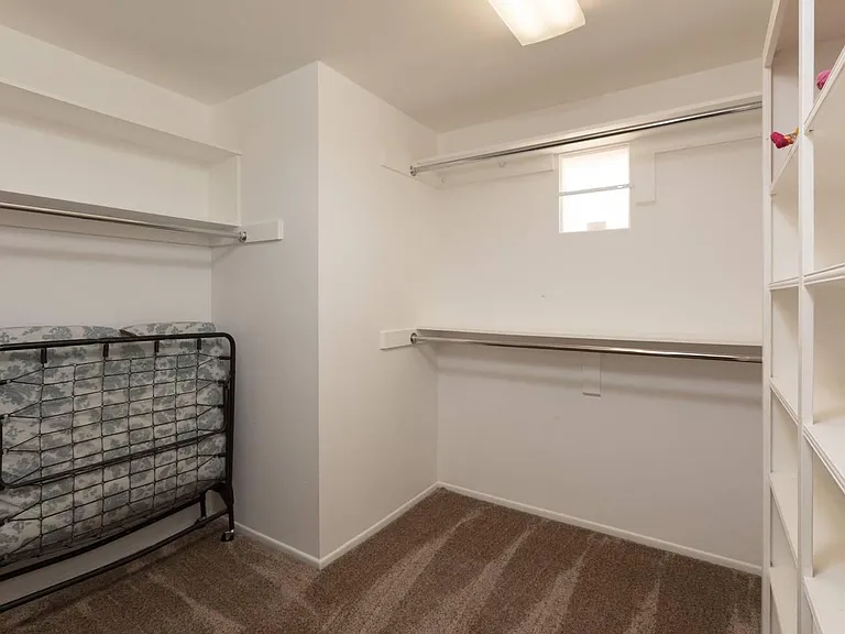 Spacious closet of second master with a roll away bed.