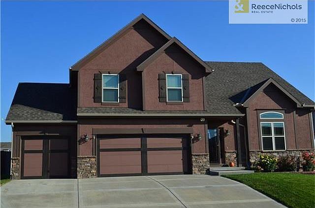 Atrium floor plan with 3 car garage
