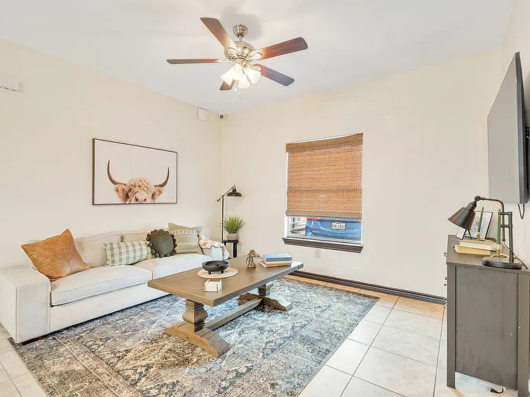 Living room in La Joya Apartments, Laredo, Texas, featuring a couch, coffee table, and television