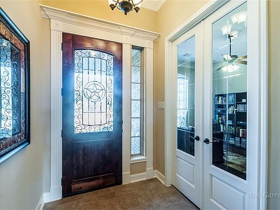 The beautiful tile entry leads to the foyer with coiffured rotunda style ceiling. The eight foot doo