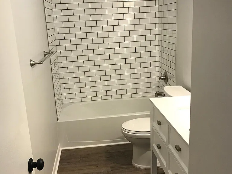 Remodeled bathroom with all new fixtures, bathtub, toilet subway tiling and vanity.