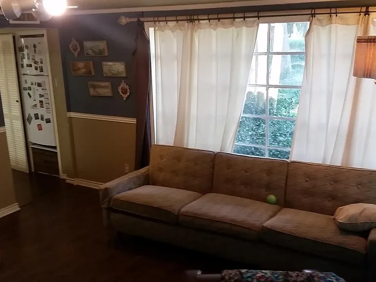 An old picture of back poolside room (Rm #2). Can see the refrigerator and pantry to the left. The area has been remodeled with new flooring, new paint, and is unfurnished.