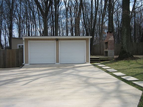 Detached garage with additional shed behind