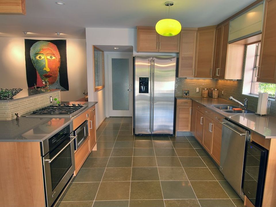 Remodeled kitchen with GE Monogram appliances, honed slate floors, glass tile