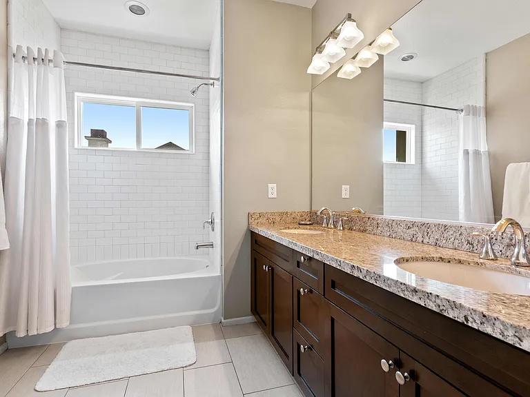 Bathroom with dual sinks and granite countertop.