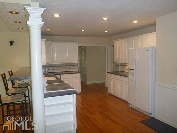 Lovely open Kitchen with gleaming hardwood floors!