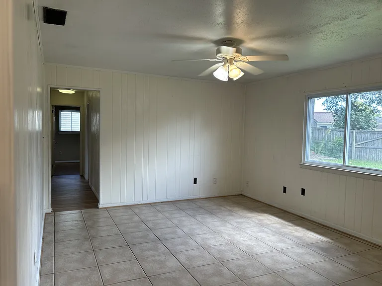 Family room with ceiling fan and tiled floors