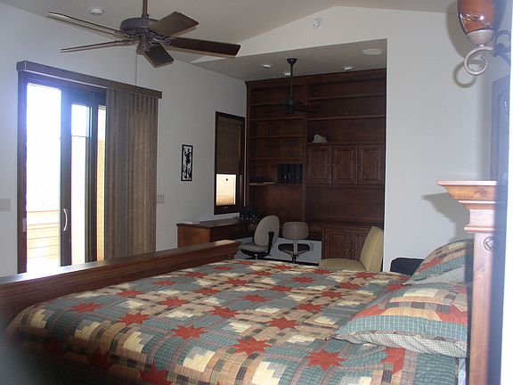 Master bedroom with custom made bookshelves and desk