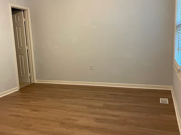 Master bedroom with high ceiling, new ceiling fan, and new luxurious flooring