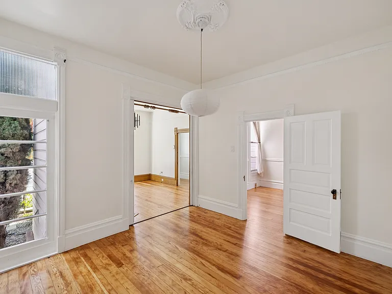 First, top-floor bedroom with large sliding doors to the parlor/family room.