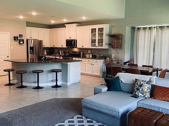 Open floor plan kitchen/livingroom with massive granite kitchen island as great social space