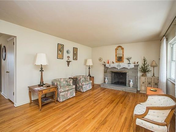 Inviting living room featuring one of 2 stone fireplaces.