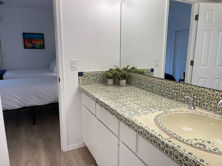 Secondary Bedroom en suite bathroom vanity area with huge counter space and beautiful hand-painted Mexican tile.