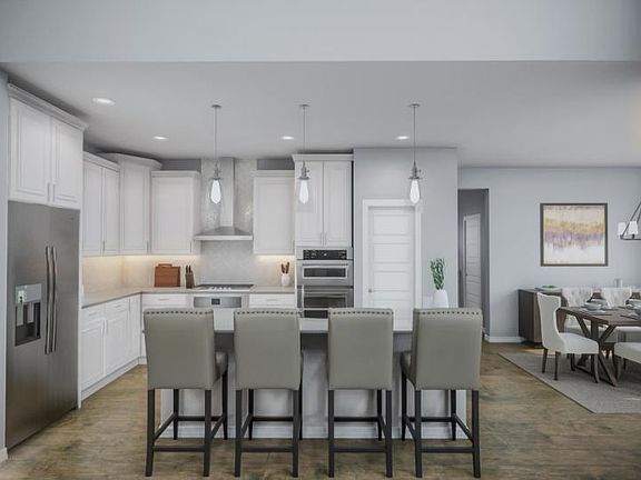 Impress guests in the kitchen with staggered cabinets, pendant lighting and tasteful cabinet and cou
