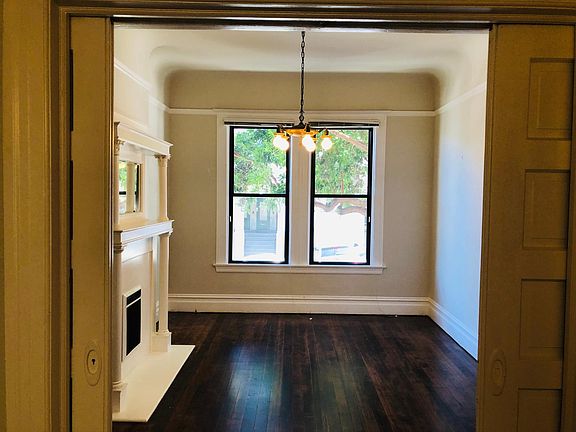 Front room Living room or bedroom w/ period detailing and newly refinished hardwood floors.