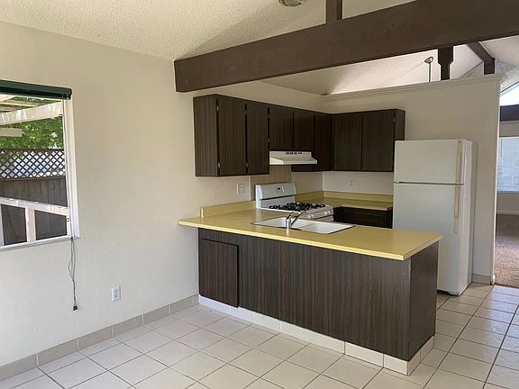 Kitchen with Open Beam Ceiling. Fridge included.
