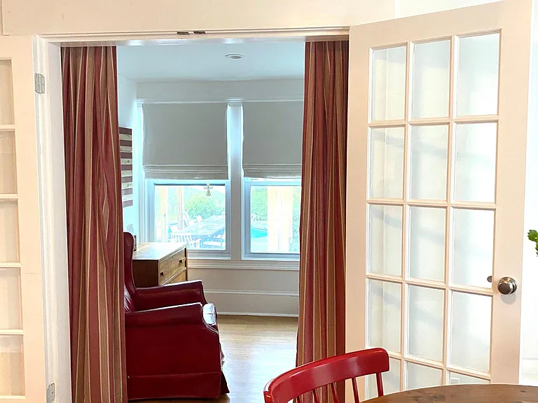 1st floor sitting room; full view of backyard gardens and pool; it can be used as home office or another guest area or just reading and relaxing