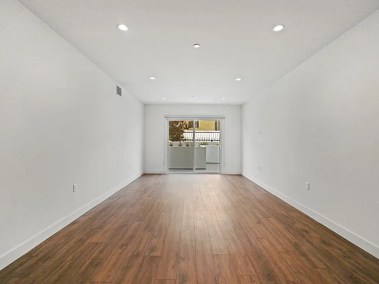 Living Room with Vinyl Flooring, Recessed Lighting, and Patio