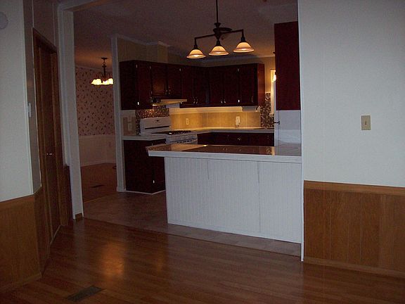 View of kitchen from family room: door to master bedroom with en suite on left