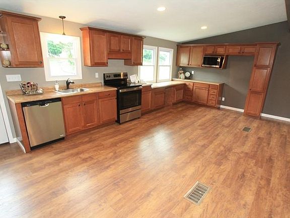 The other half of the open main floor is the kitchen space with wonderful cabinetry and counter top 