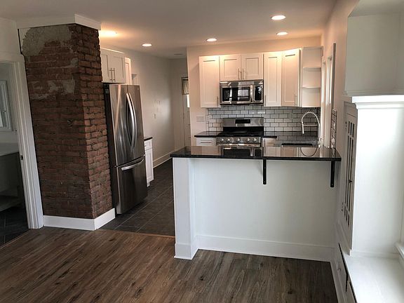 Open concept kitchen, exposed brick