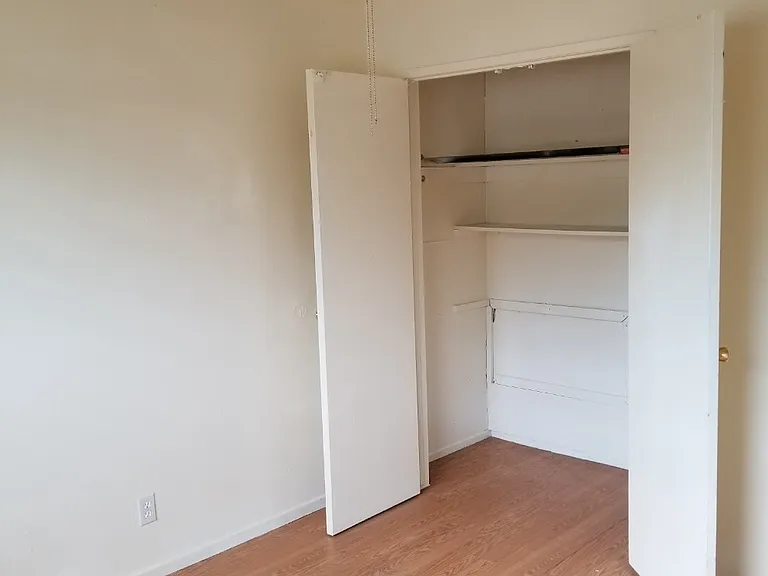 Another angle of bedroom #1 with open door spacious closet