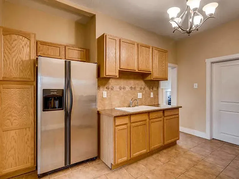 Tall cabinets, as well as those above and below the sink area, provide ample kitchen storage